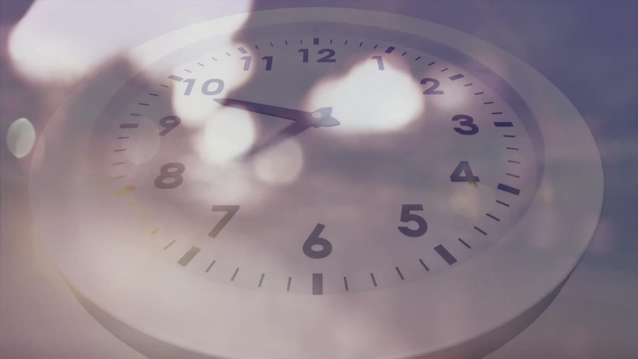 Animation of moving clock over light spots and cars on street