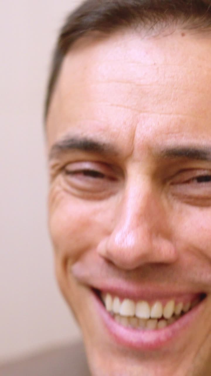 Successful businessman puts on his jacket in the bathroom