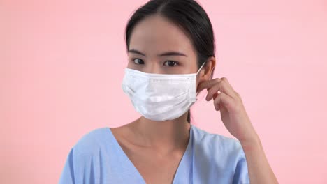 Young-Asian-woman-take-off-face-mask-removing-from-face