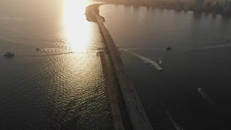 aerial view of miami cityscape, tilt down reveals william powell bridge, sunset