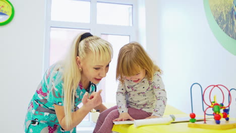 doctor examining young girl. cute little girl attending medical check up