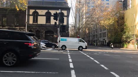 vehicles and motorbike crossing intersection in melbourne