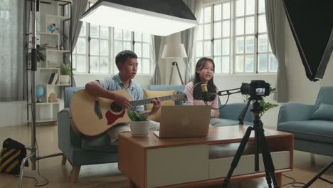 kids singing and playing guitar at home