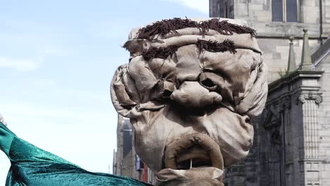 slow motion shot of toy puppet face in edinburgh old town markets scotland castle uk 1920x1080