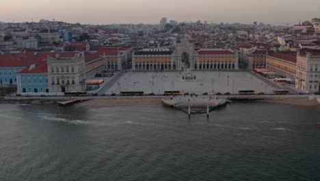 Fast-aerial-slider-view-over-the-ocean-of-Praca-do-Comercio-public-square-and-Arco-da-Rua-Augusta-in-Lisbon-city-center-by-the-coast