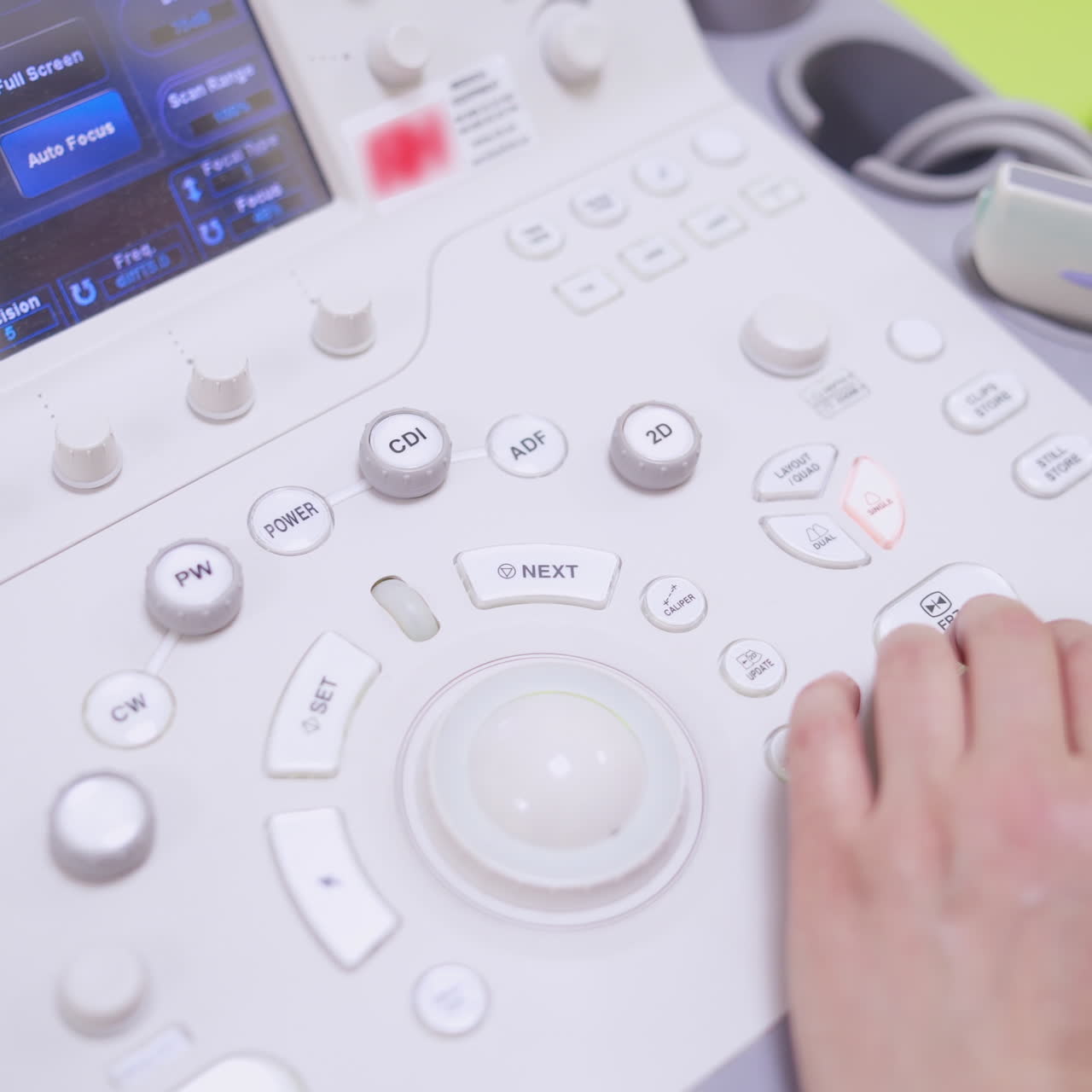 Modern ultrasound machine. Doctor presses buttons on ultrasound machine during making the diagnostics of a patient in clinic. Close-up.