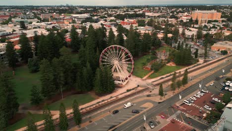 drone shot around fremantle ferris wheel in perth suburbs in western australia with the harbour in the background