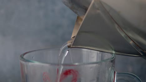 pouring hot water into a cup