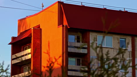 apartment building in golden hour sunlight with orange facade