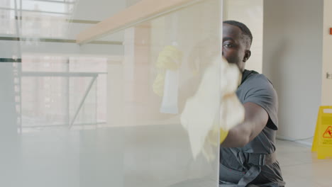 Close Up View Of Cleaning Man Cleaning Crystal Walls Inside An Office Building