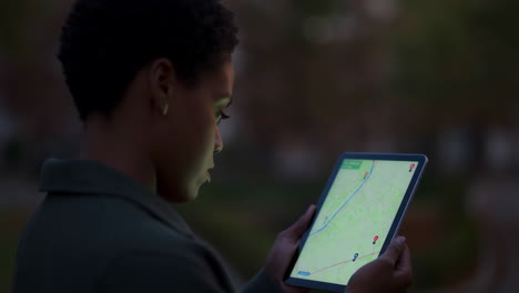 woman using a tablet to navigate at night