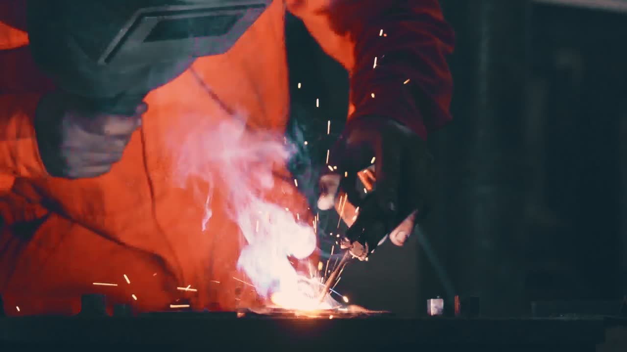 Metal welder working with arc welding machine