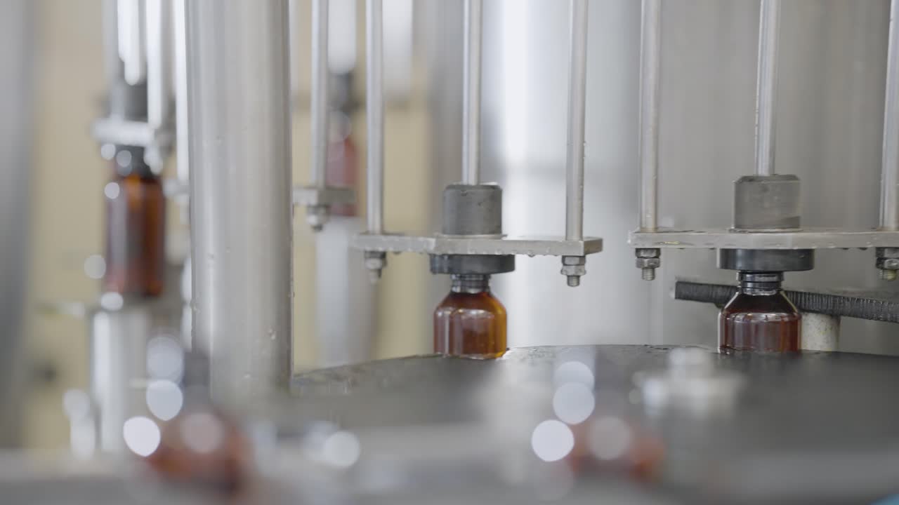 Syrup Bottles getting filled with liquid medicine.