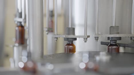 syrup bottles getting filled with liquid medicine.