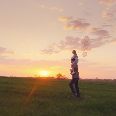 Father-Carries-His-Daughter-With-Balls-Across-The-Field-At-Sunset-1