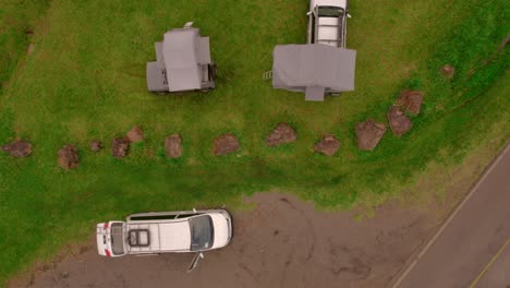 bird-eye aerial over camping vans and built up tents on it, outdoor car exploration, vacation and camping concept