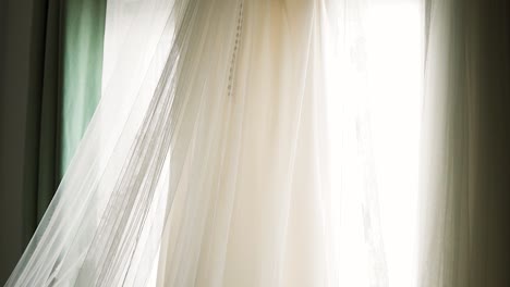 wedding dress hung up and prepared for a wedding