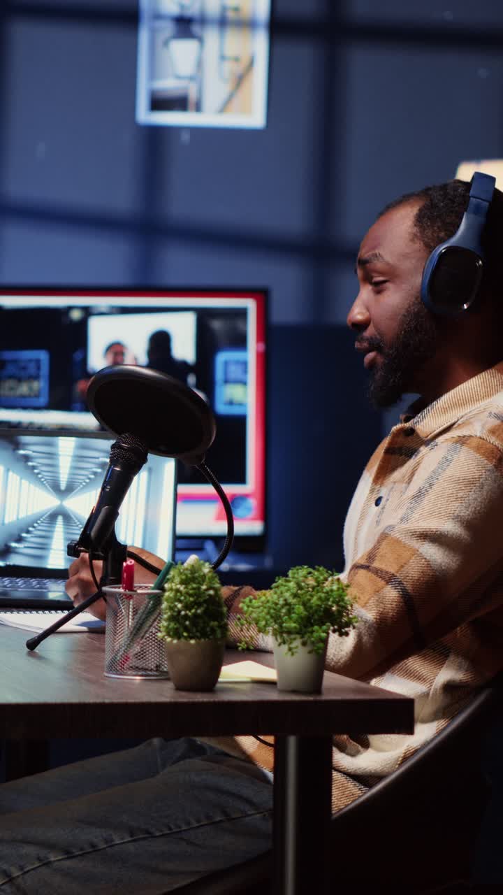 Vertical video Show host recording podcast with guest, using audio recording equipment in home studio