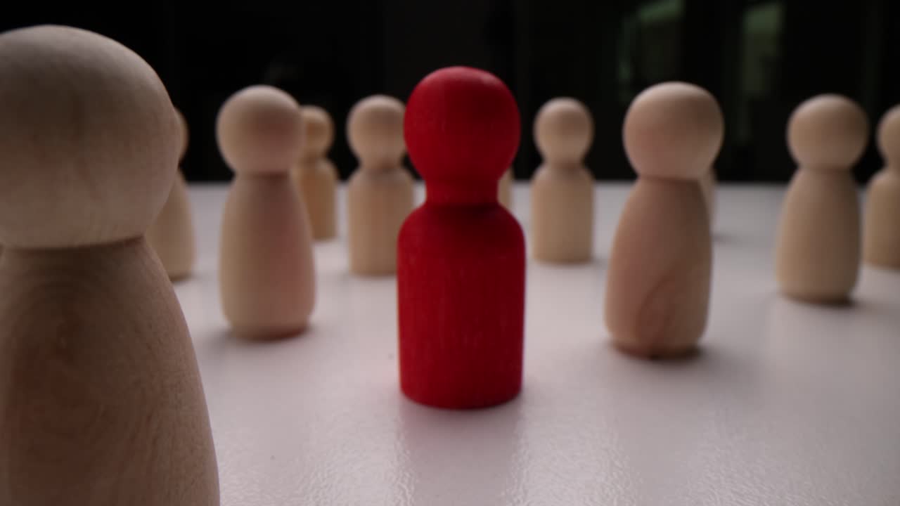 Wooden Figures Symbolizing Leadership and Individuality