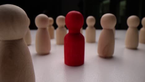 wooden figures symbolizing leadership and individuality