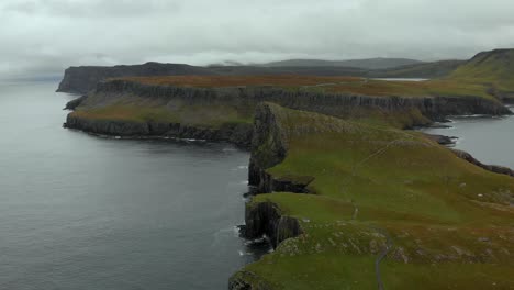 aerial footage of neist point on the isle of skye, scotland, uk. standing at 62ft, neist point is one of the most famous lighthouses in scotland and can be found on the most westerly tip of skye.