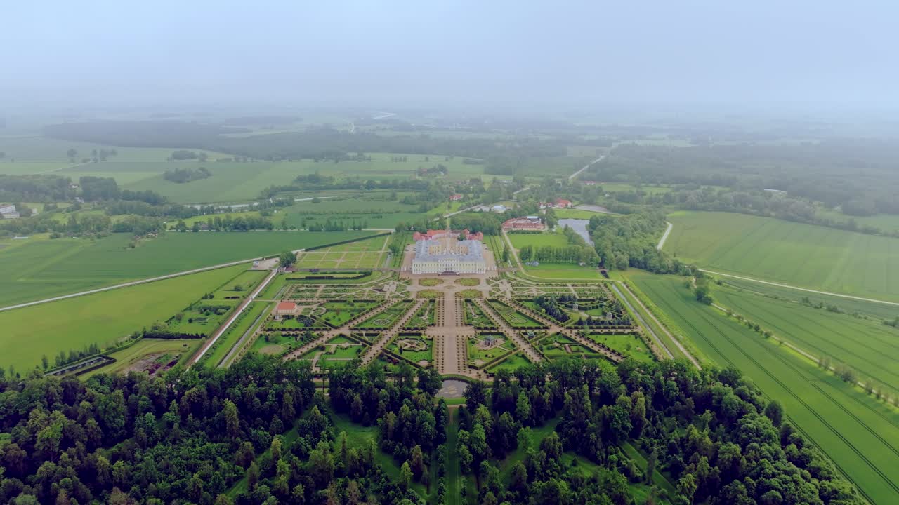 Cinematic drone flight through clouds reveals Rundale Palace and French garden