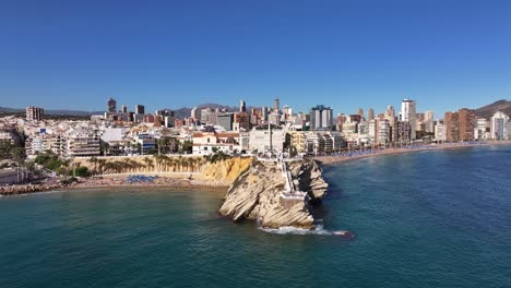 benidorm coastline, showcasing urban buildings and clear blue sea, aerial view