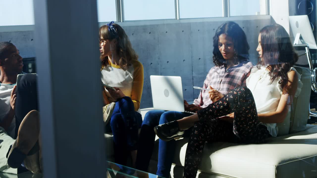 Woman in yellow sleeves placing notepad and leading business meeting while HUD reflections shifting