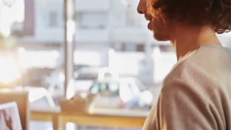 man receiving sandwich and coffee at counter