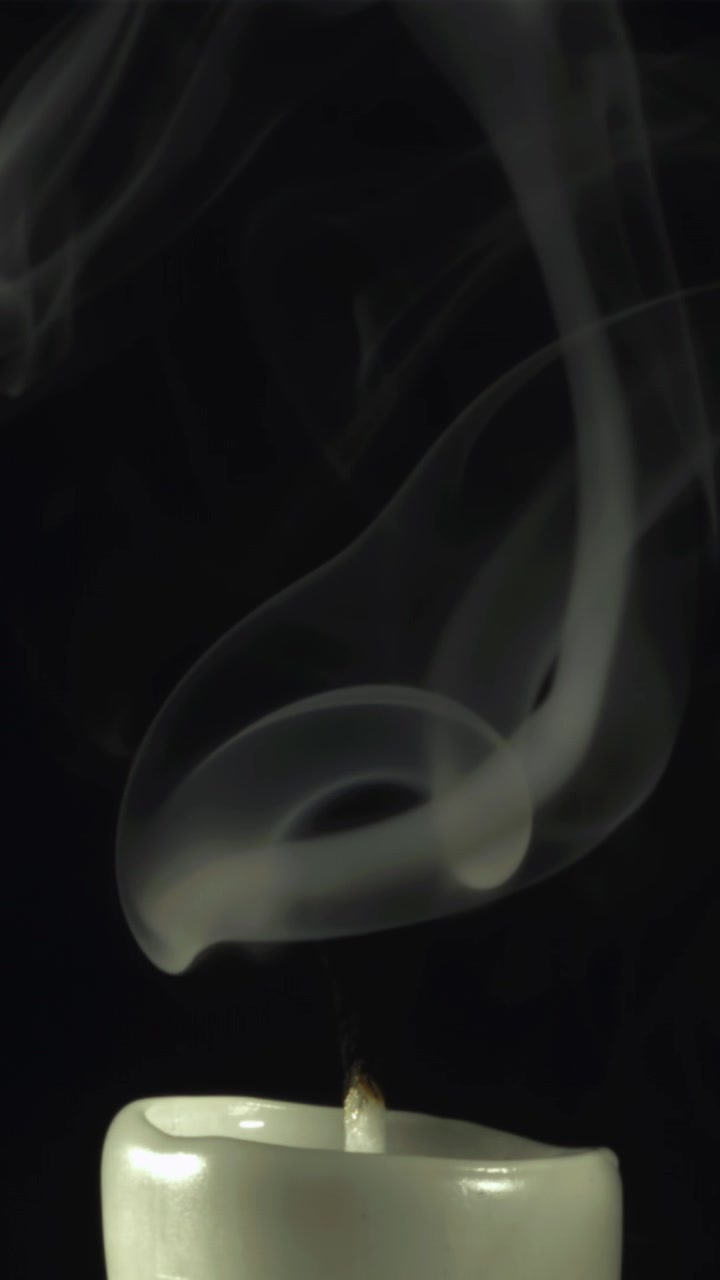 White Smoke Swirling from Extinguished Candle in Slow Motion