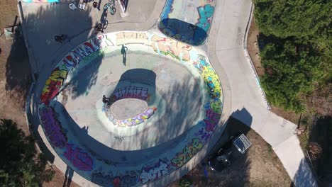 drone shot vertical top view over a skatepark in south of france. young bmx ride