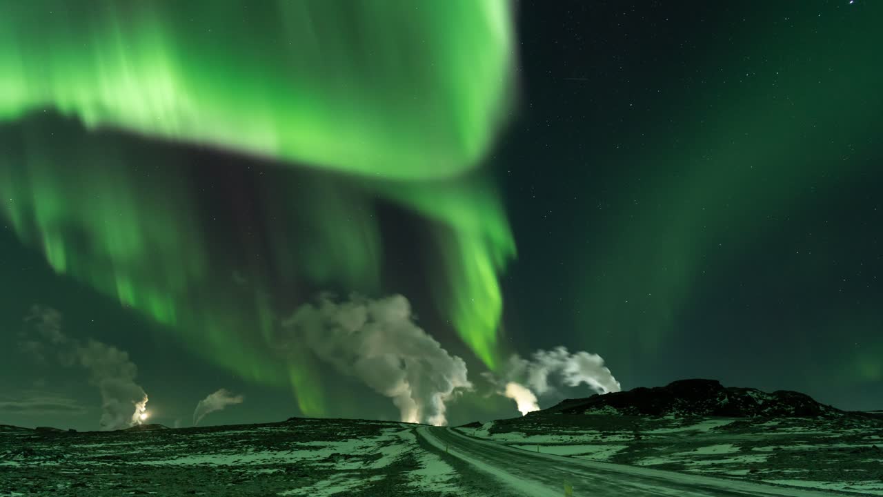 Stable timelapse at 25 frames per second shows dancing aurora above a geothermal powerplant.