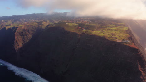 Aerial-view-of-Ponta-Do-Pargo-Lighthouse-and-colorful-rocky-landscape-during-sunny-day-on-Madeira-Island