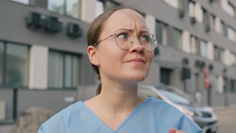 Close-up-of-young-woman-frowning-into-camera,-offended