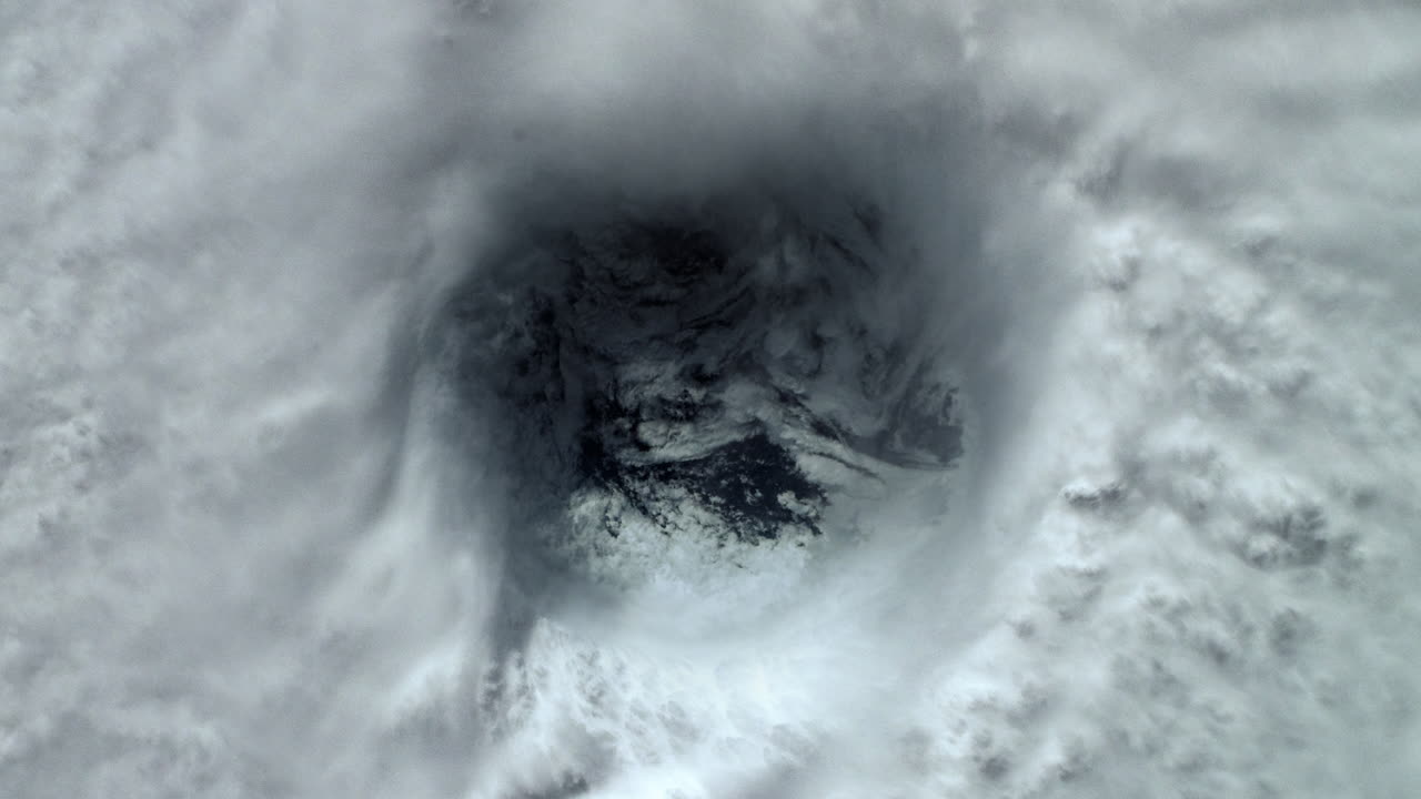 Eye of the Storm in a Hurricane Over the Ocean with Dense Swirling Clouds Rotating Creating Cyclone. View from Above in Space of Extreme Weather. ProRes Animation 4K.
