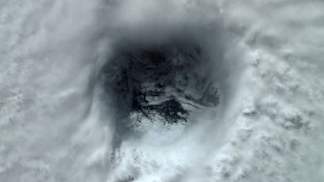eye of the storm in a hurricane over the ocean with dense swirling clouds rotating creating cyclone. view from above in space of extreme weather. prores animation 4k.