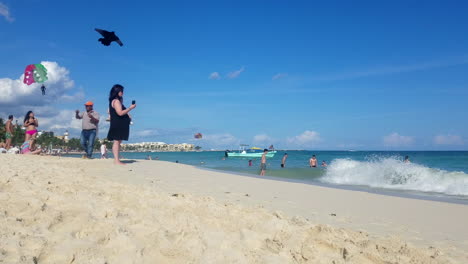 mexican haucker man flying and selling a james bond parachute figure toy on the beach
