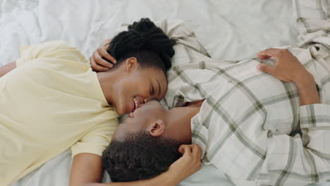 Couple,-black-woman-and-kiss-on-bed-together