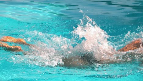 fit swimmer doing the butterfly stroke in the swimming pool