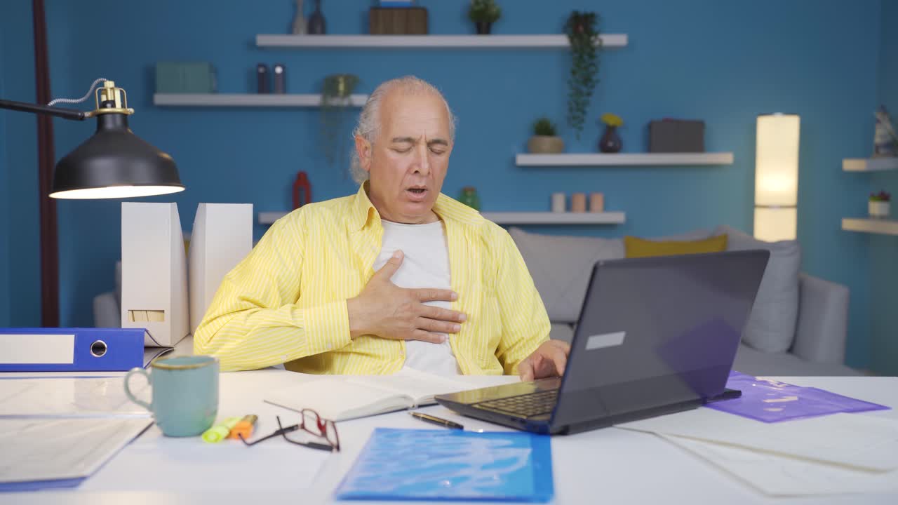 Home office worker old man suffering from shortness of breath.
