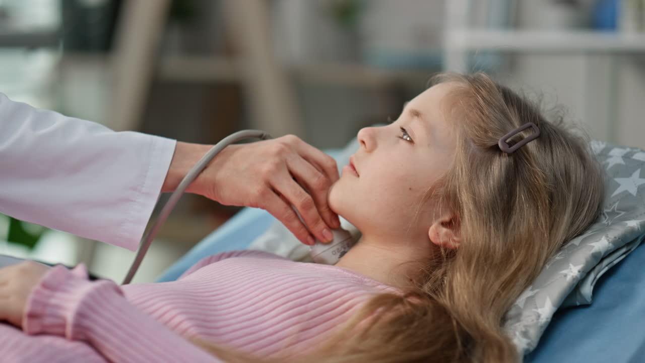 Smiling woman examining patient with ultrasound machine. Closeup girl visiting