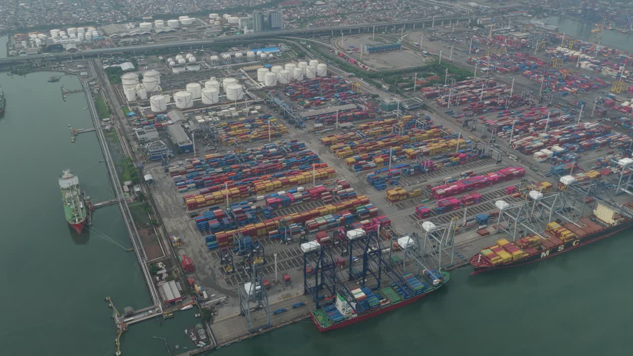 Busy Jakarta shipping harbor with cargo containers and freight vessels