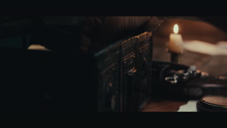 an old captain opens an old document chest inside the sailing ship cabin