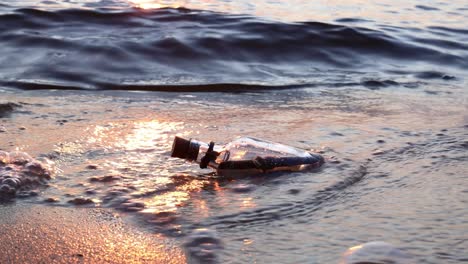 message in the bottle against the sun setting down