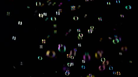 rainbow soap bubbles fly black background rainbow soap bubbles fly in the air and burst black backround