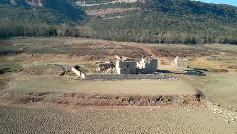 sau swamp dike in catalonia, spain, intense drought in 2024 views of a village that is normally submerged