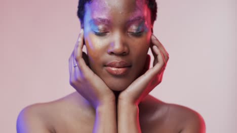 African-american-woman-with-short-dark-hair-in-blue-and-pink-light,-slow-motion