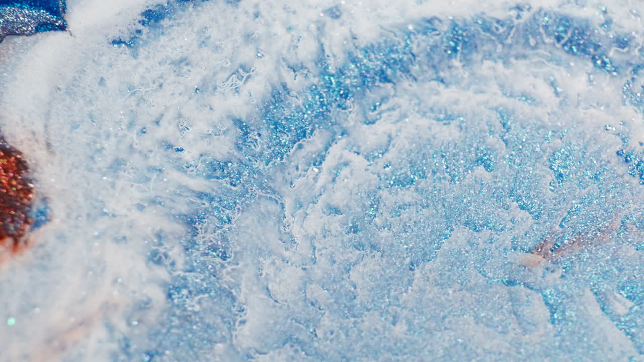 Ink drop motion creating abstract forms, macro view