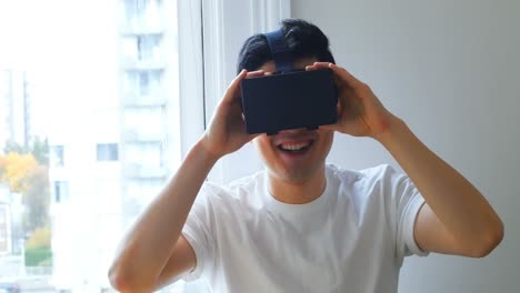 Man-using-virtual-reality-headset-at-home-4k