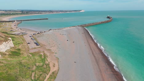 a serene look at the sea and a lighthouse from above the cliffs of newhaven